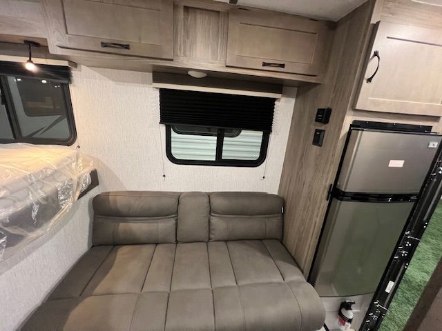 An RV with a couch and a refrigerator in it.
