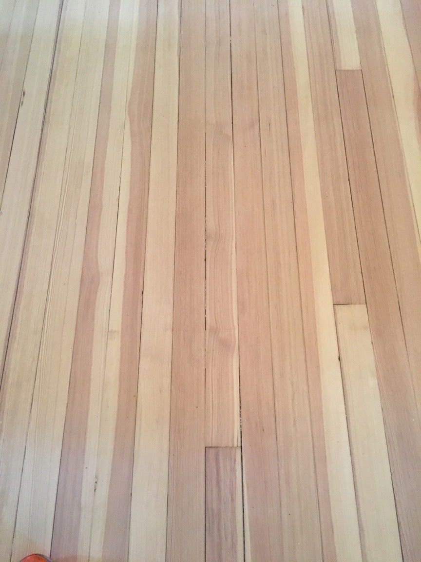 Light-colored hardwood floor with vertical grain pattern.