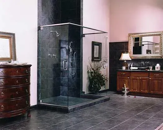Luxury bathroom with dark tile shower, wooden vanity, mirror, and tiled floor