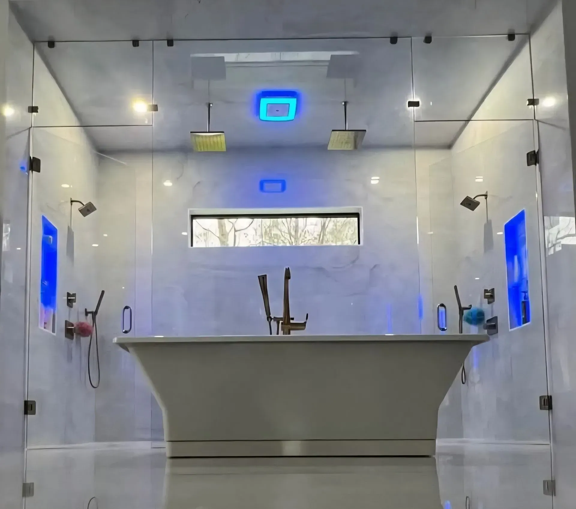 Modern white shower room with a freestanding tub, blue-lit mirrors, and polished concrete floor