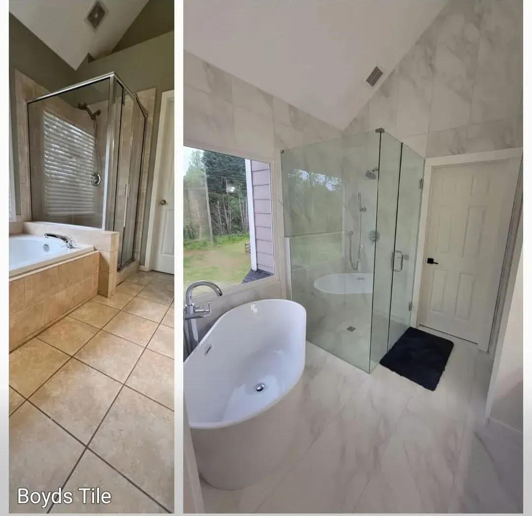 Luxury bathroom with freestanding tub, glass shower, marble walls, and tan tile floor.