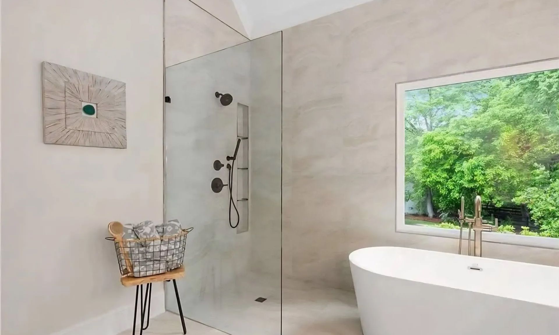 Modern bathroom with walk-in shower, freestanding tub, and a window overlooking greenery
