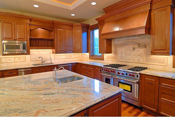 A kitchen with stainless steel appliances and granite counter tops.