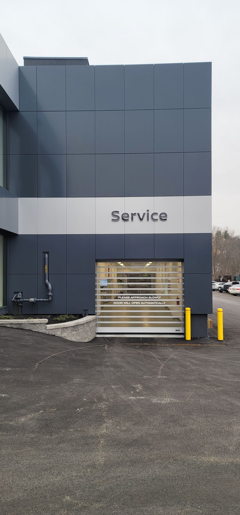 A large building with a garage door that says service on it.