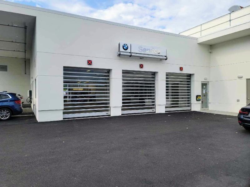 A car is parked in front of a bmw service center.