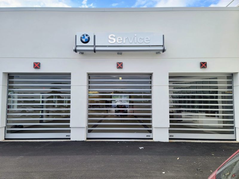 A car is parked in front of a bmw service garage