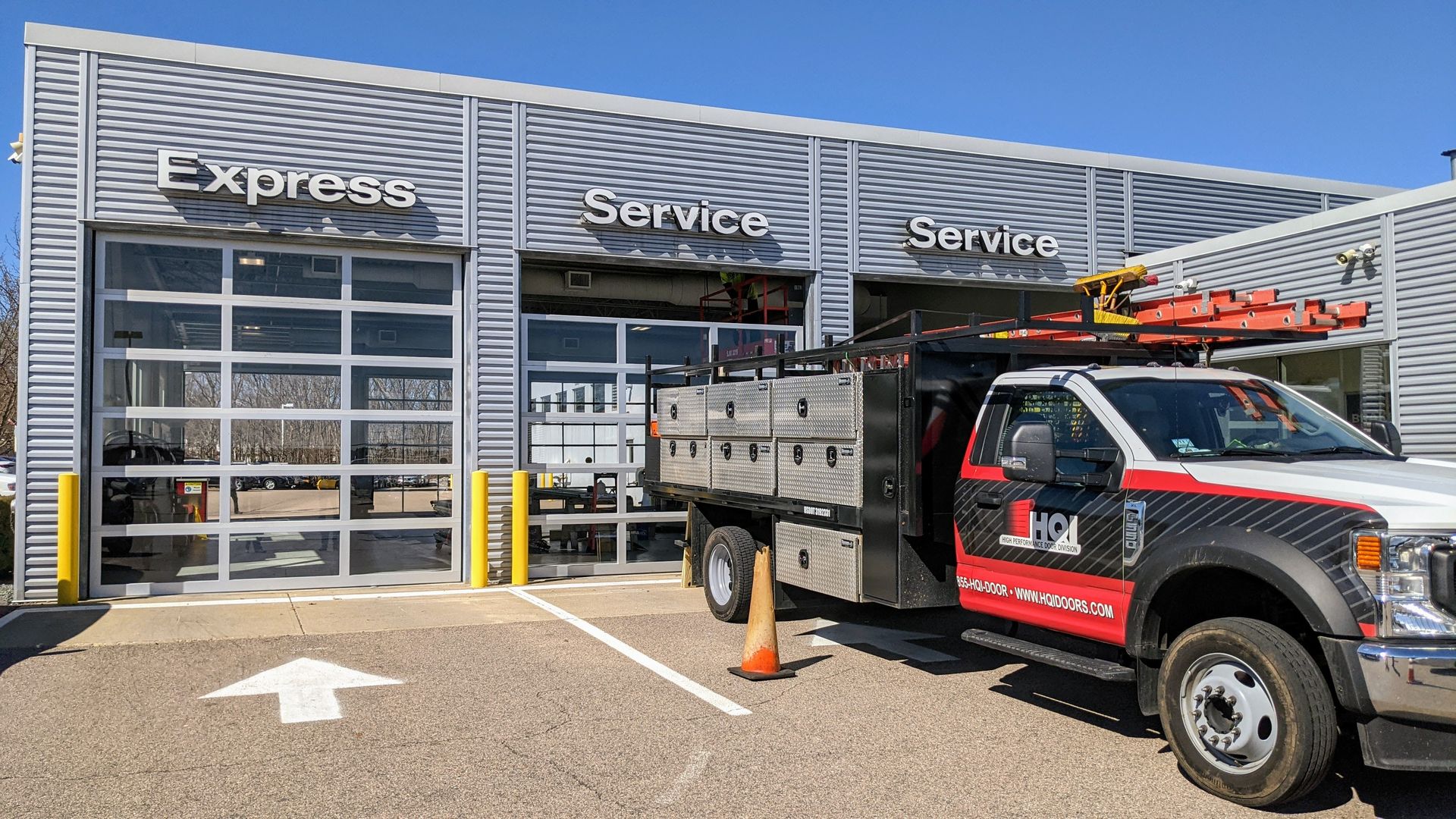 A truck is parked in front of a service building.