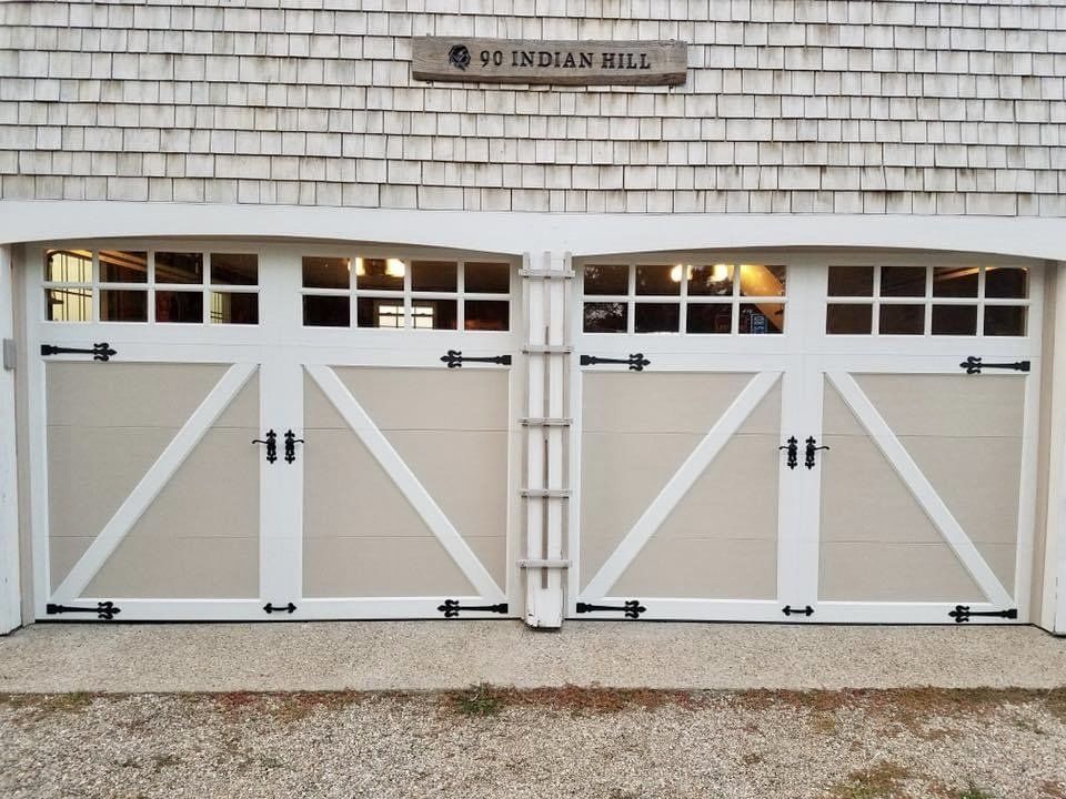 A white garage door with a sign above it that says indian hill