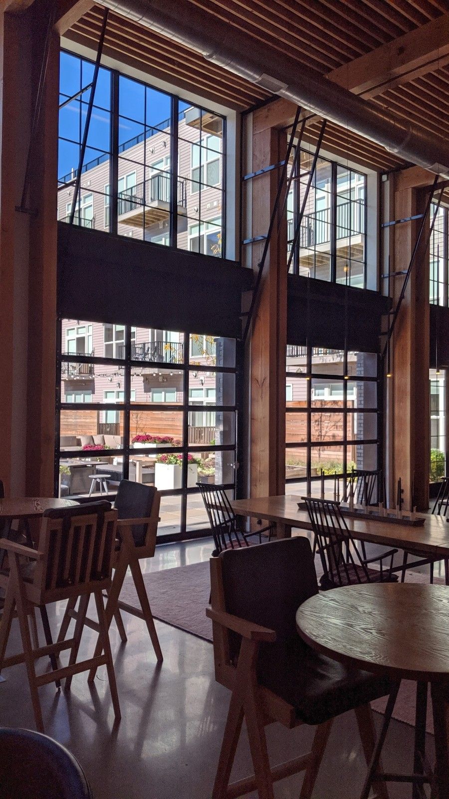 A restaurant with tables and chairs and a lot of windows