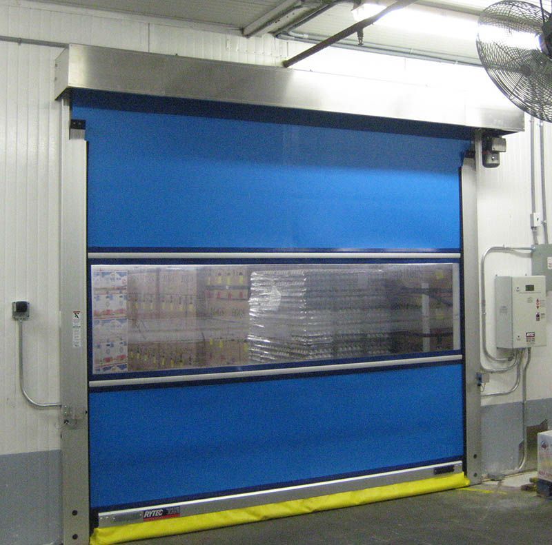 A blue door in a room with a fan