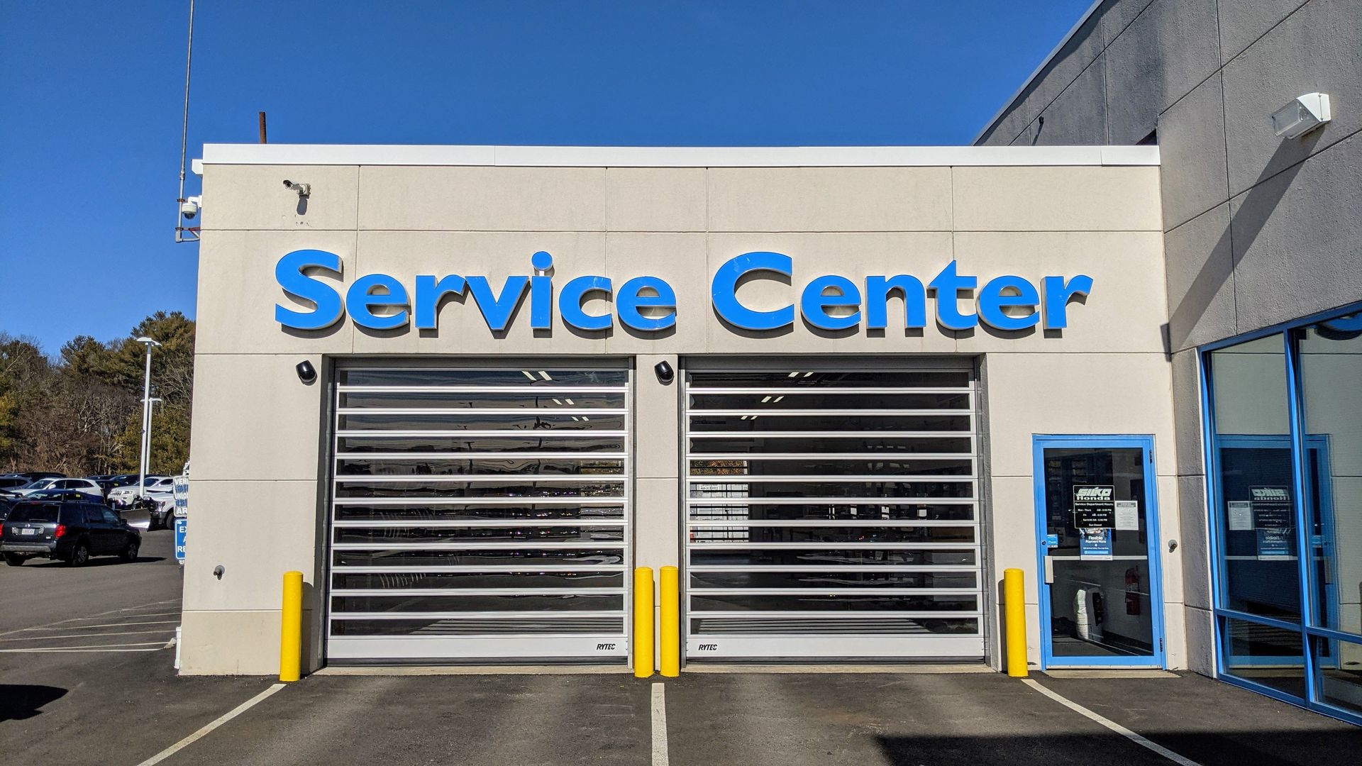 A service center with a lot of cars parked in front of it