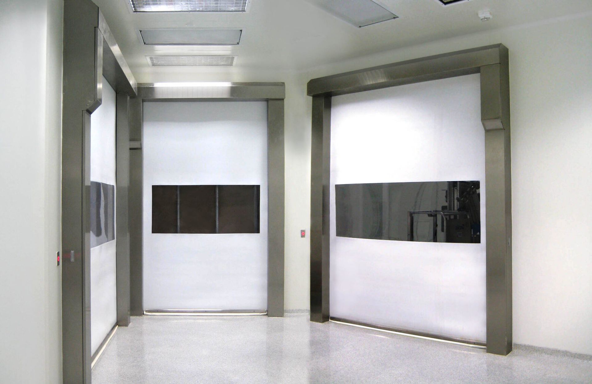 A hallway with a white door and a black door