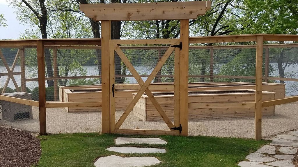 A wooden fence with a gate in the middle of it