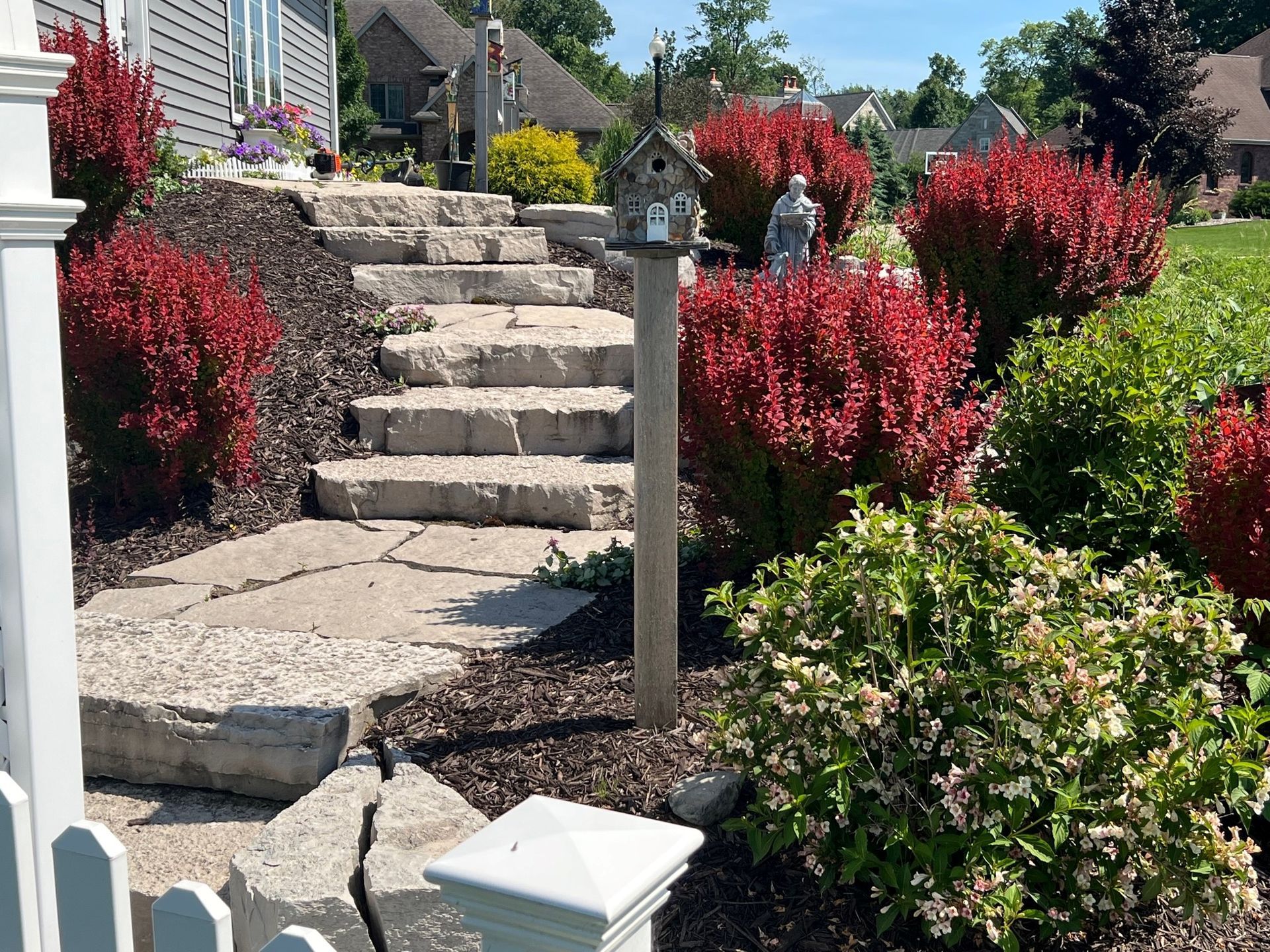A stone walkway with stairs leading up to a house