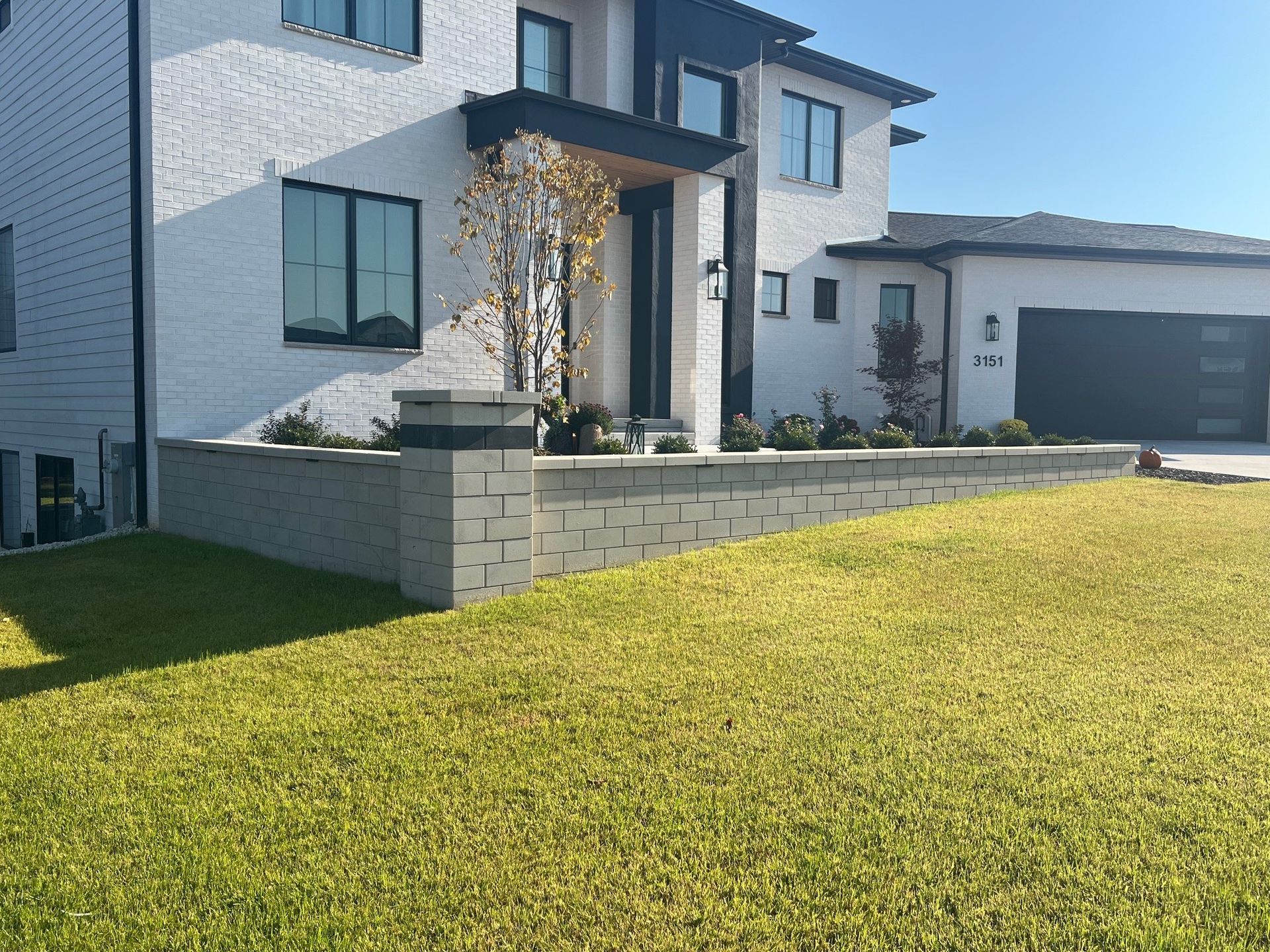 A large white house with a large lawn in front of it