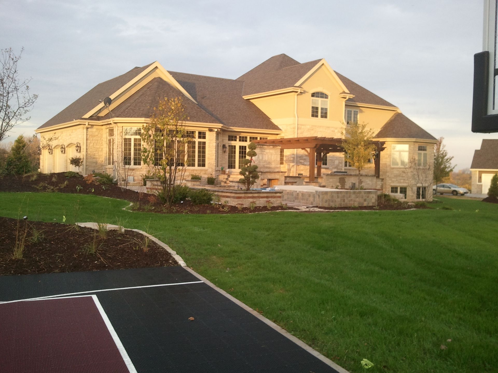 A large house with a basketball hoop in front of it