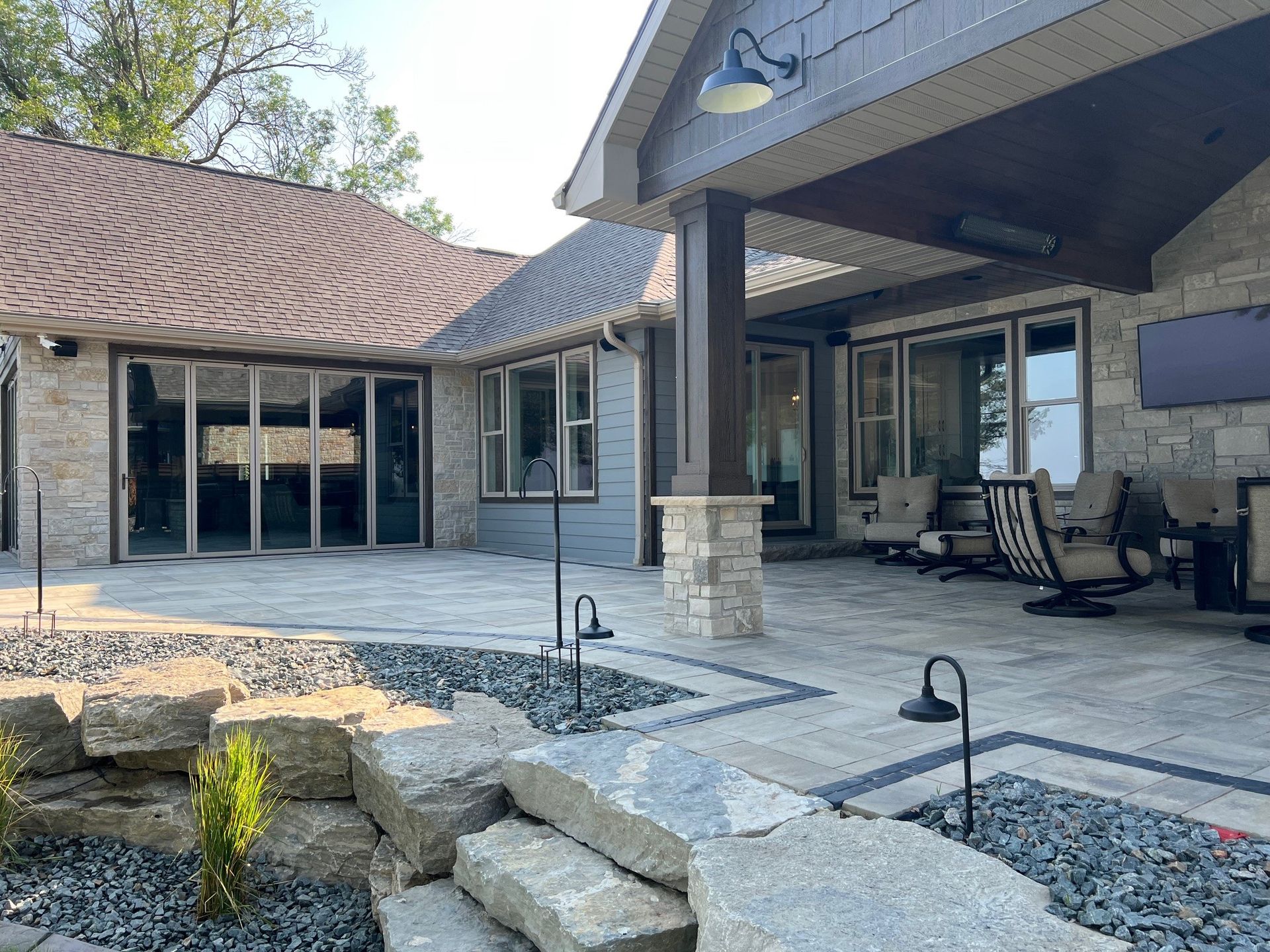 A large house with a patio and stairs in front of it