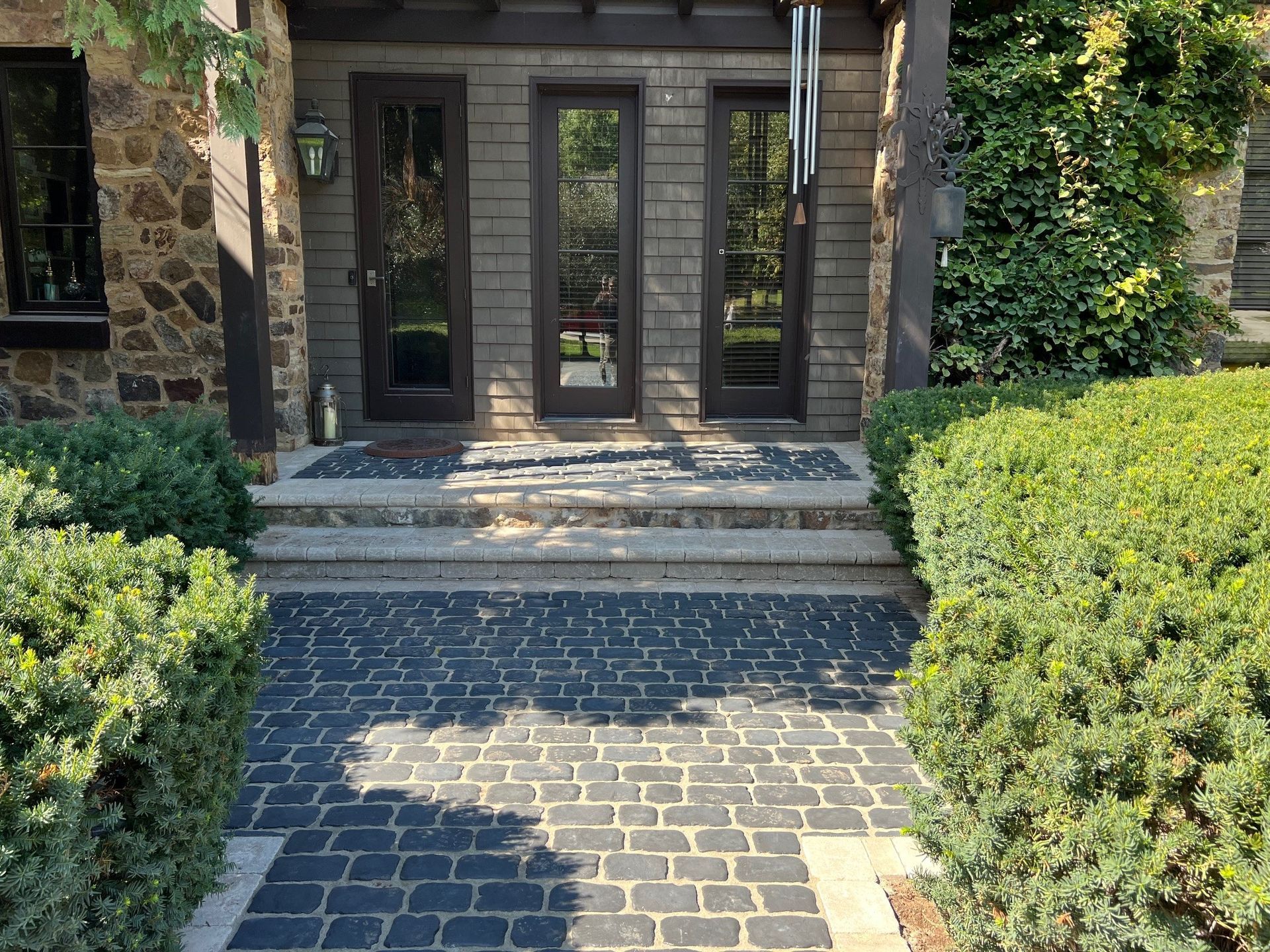 There is a stone walkway leading to the front door of a house