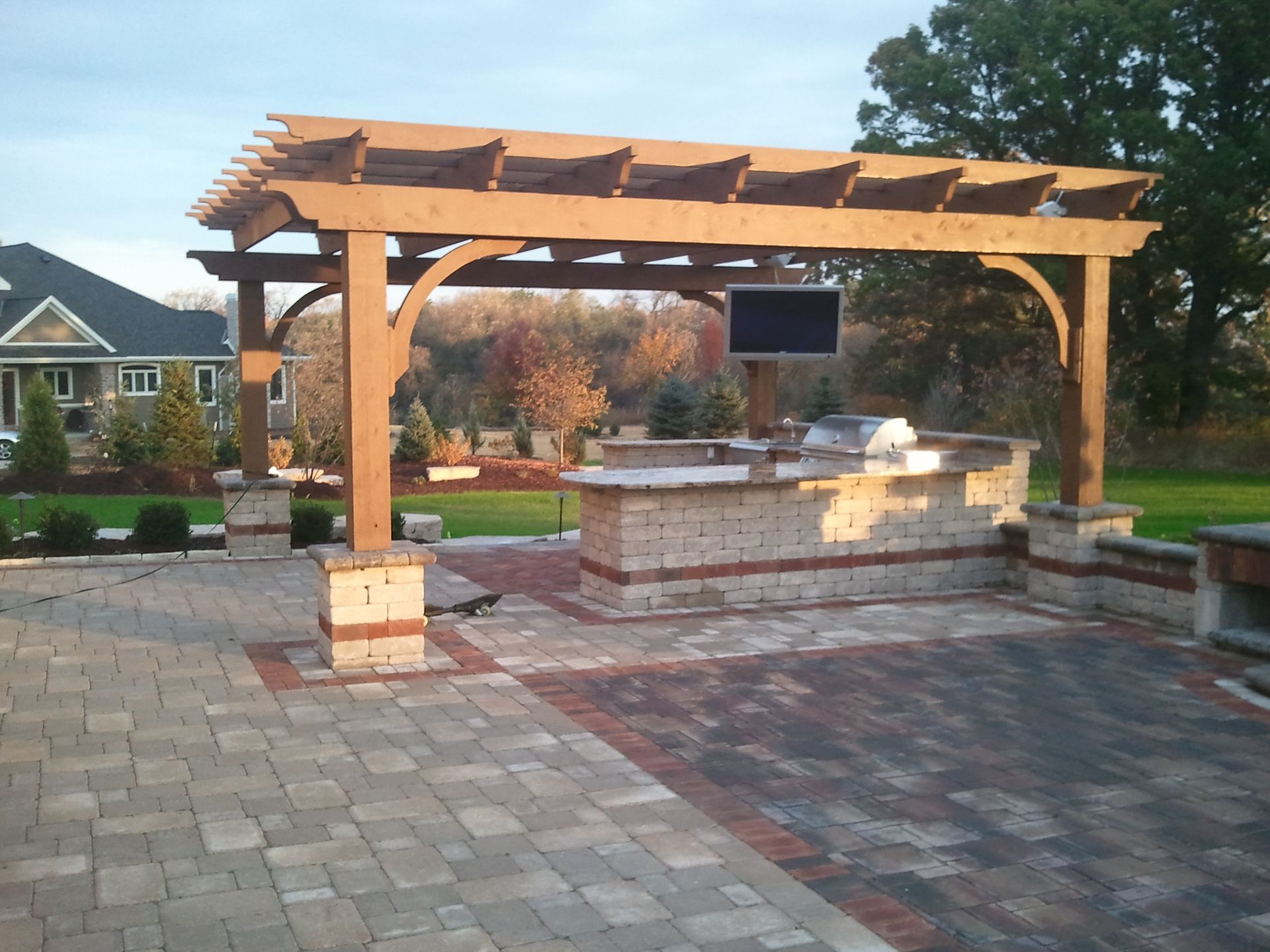 A wooden pergola with a tv