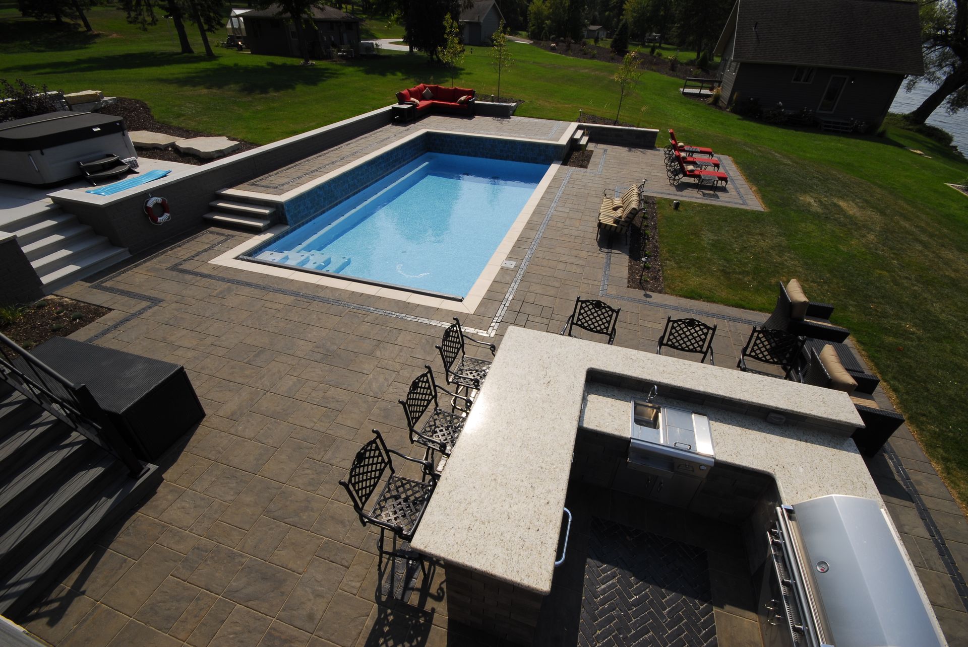 An aerial view of a large swimming pool and patio area