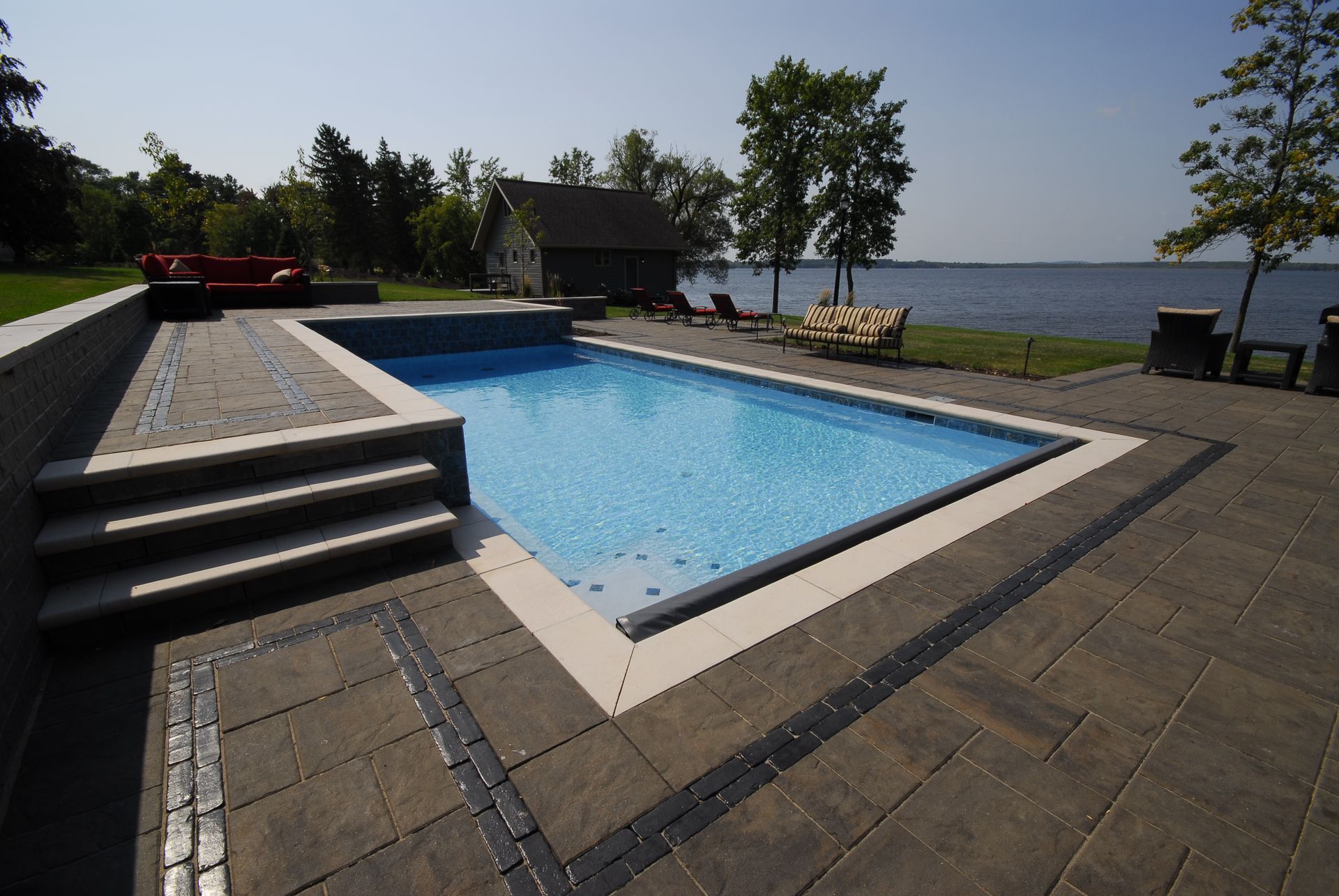 A large swimming pool with stairs leading up to it