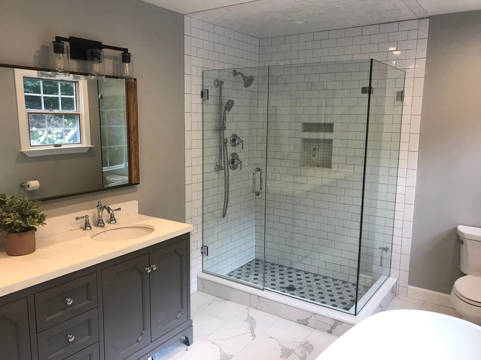 Modern bathroom with double vanity and large glass-enclosed shower