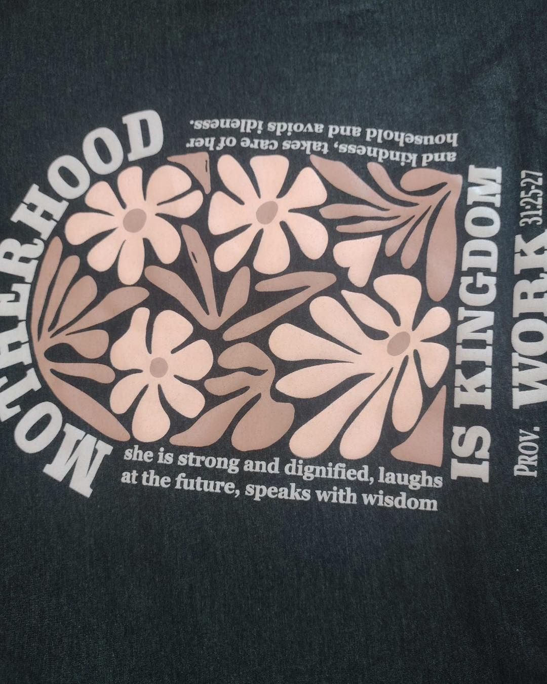 Dark green t-shirt with floral design and text: 