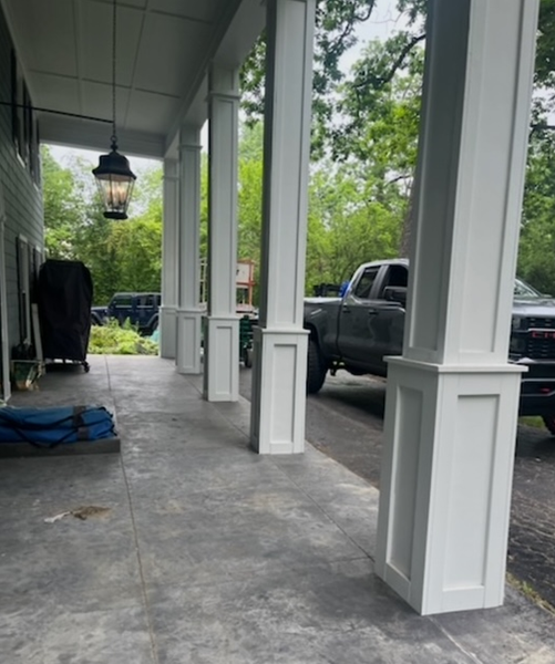 A truck is parked on the porch of a house