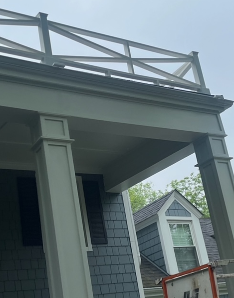 A house with a porch and a fence on top of it