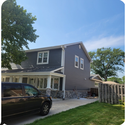 A black van is parked in front of a house