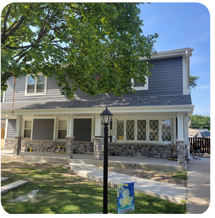 A house with a tree in front of it and a lamp post