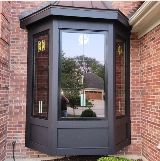 A brick building with a bay window on the side