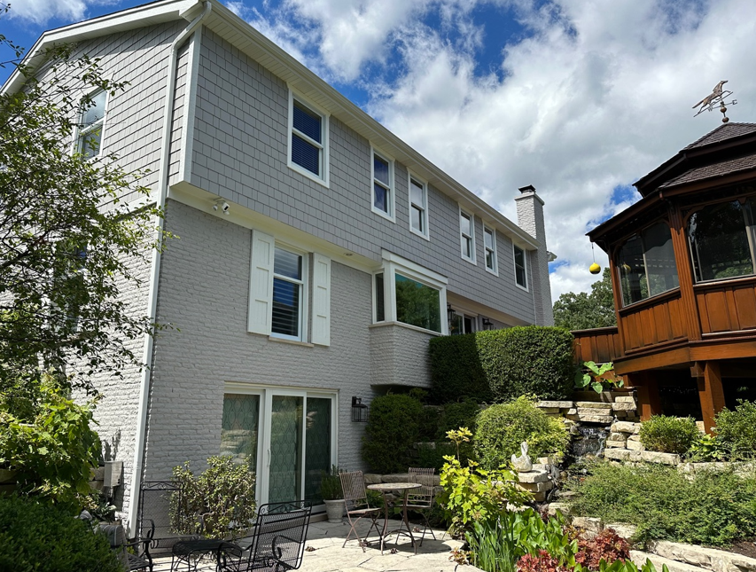 A large house with a patio and a gazebo in the backyard.