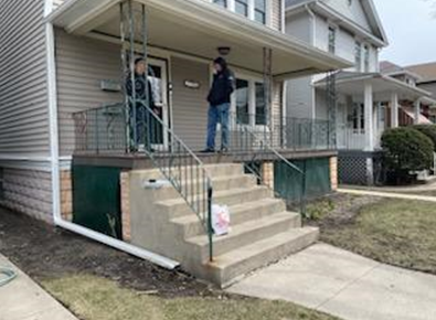 stairs with two people standing outside the house