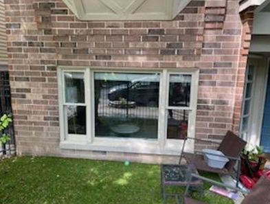 rectangular window with lawn chair in front