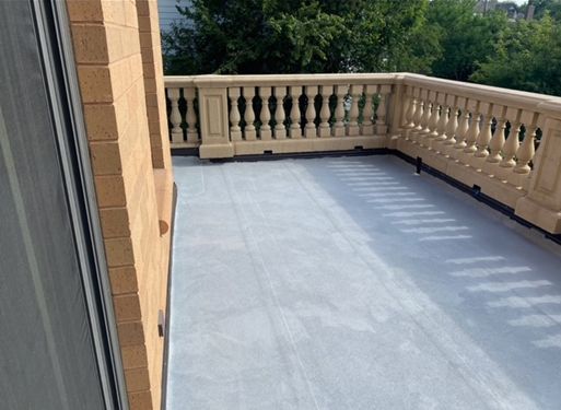 A balcony with a railing on the side of a building