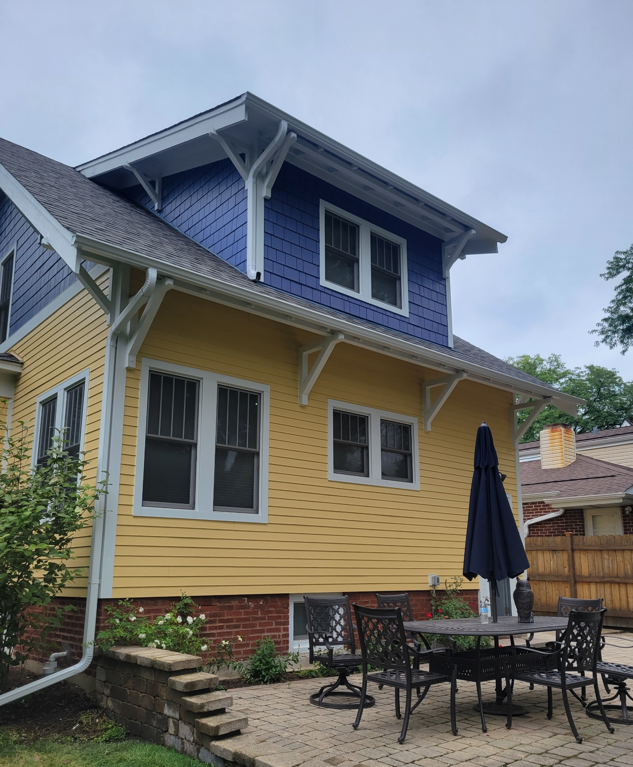 Purple and yellow house with chairs and table