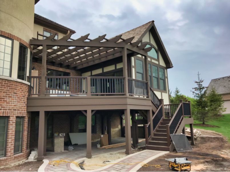 A large house with a large deck and stairs