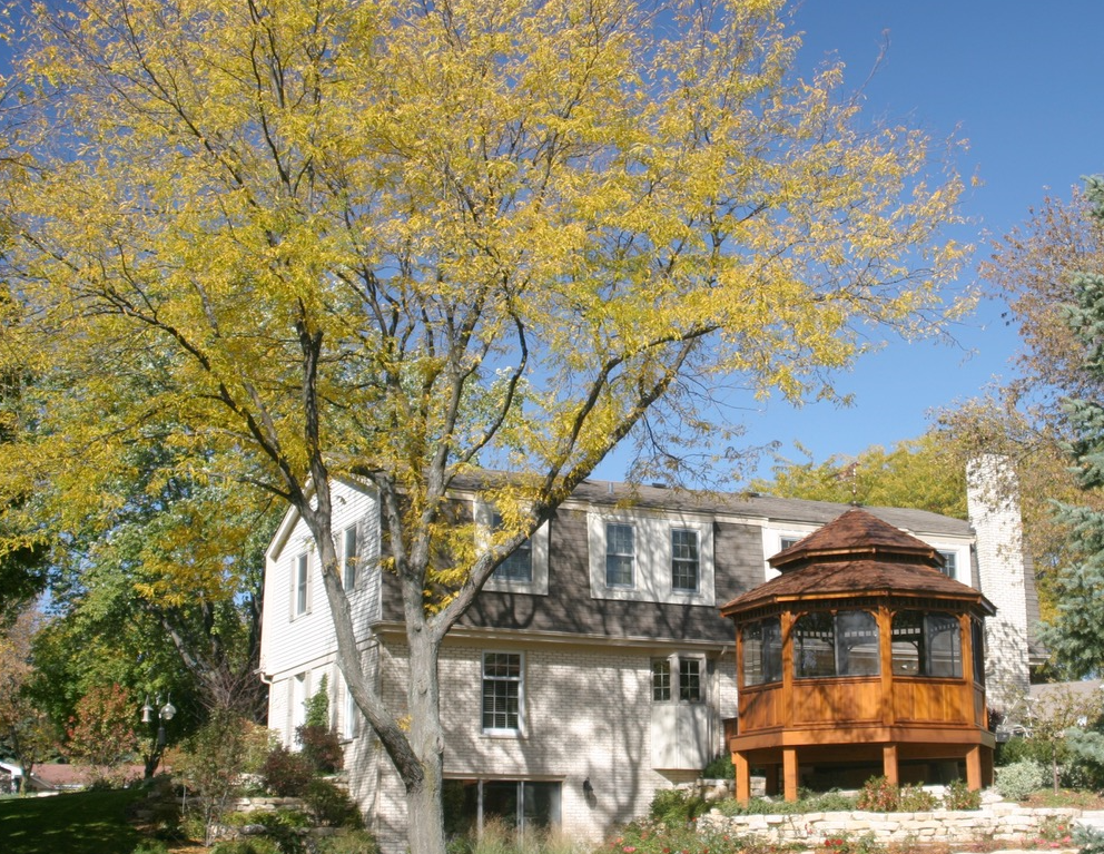 A large house with a gazebo in front of it.