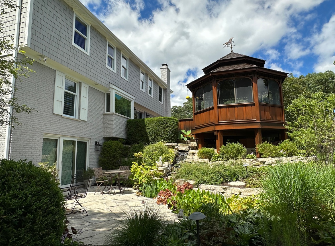 A large house with a gazebo in the backyard.