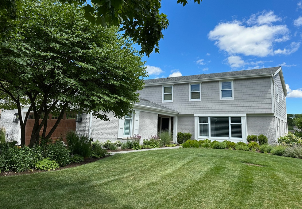A large house with a lush green lawn in front of it