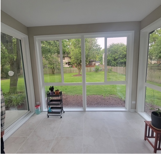 A room with a lot of windows and a view of a yard