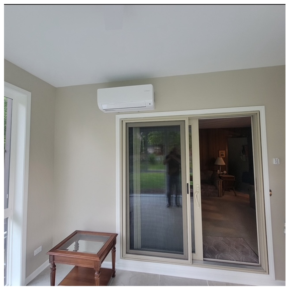 A room with a sliding glass door and a table