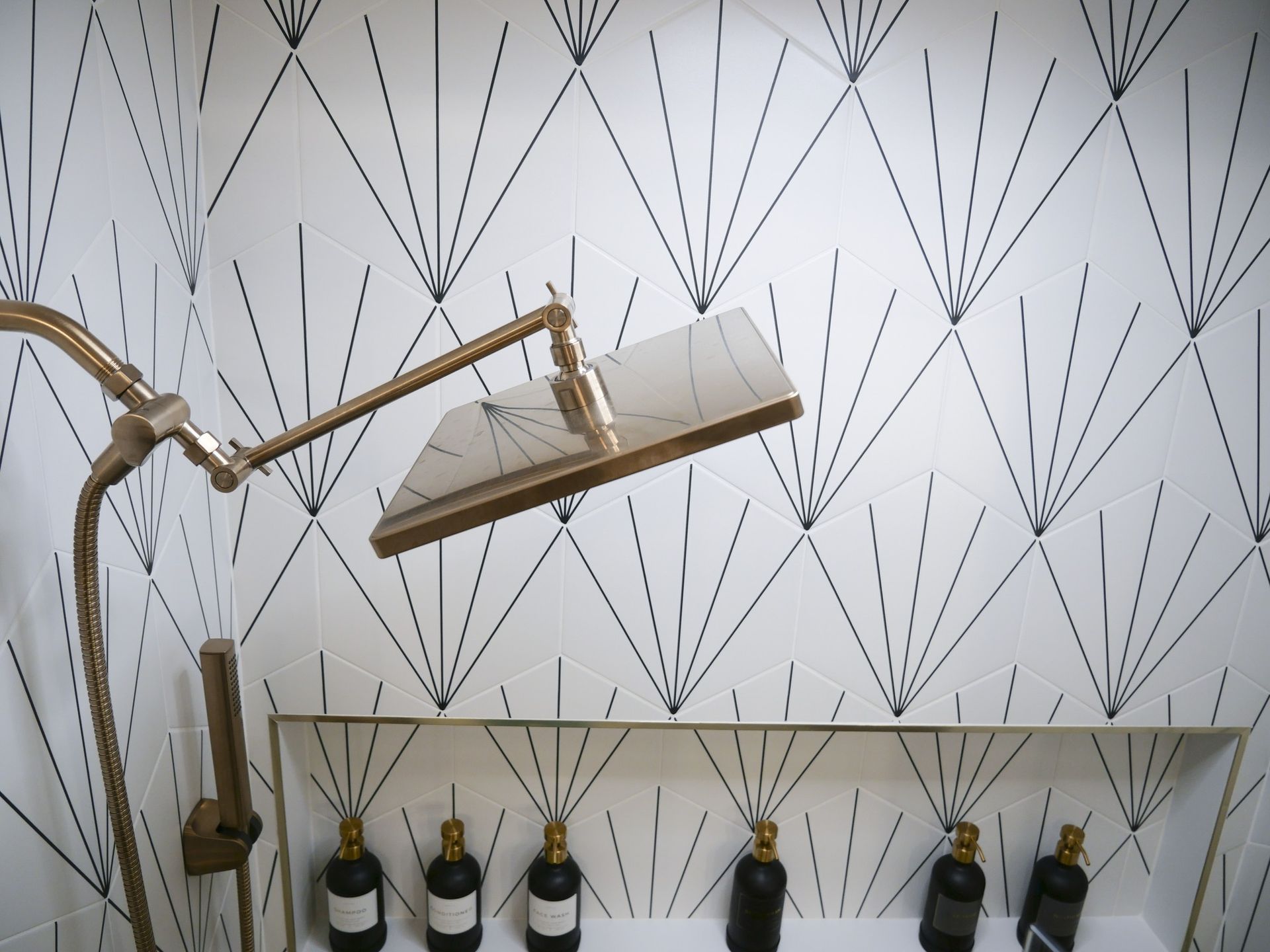 A bathroom with a lamp and bottles on the wall