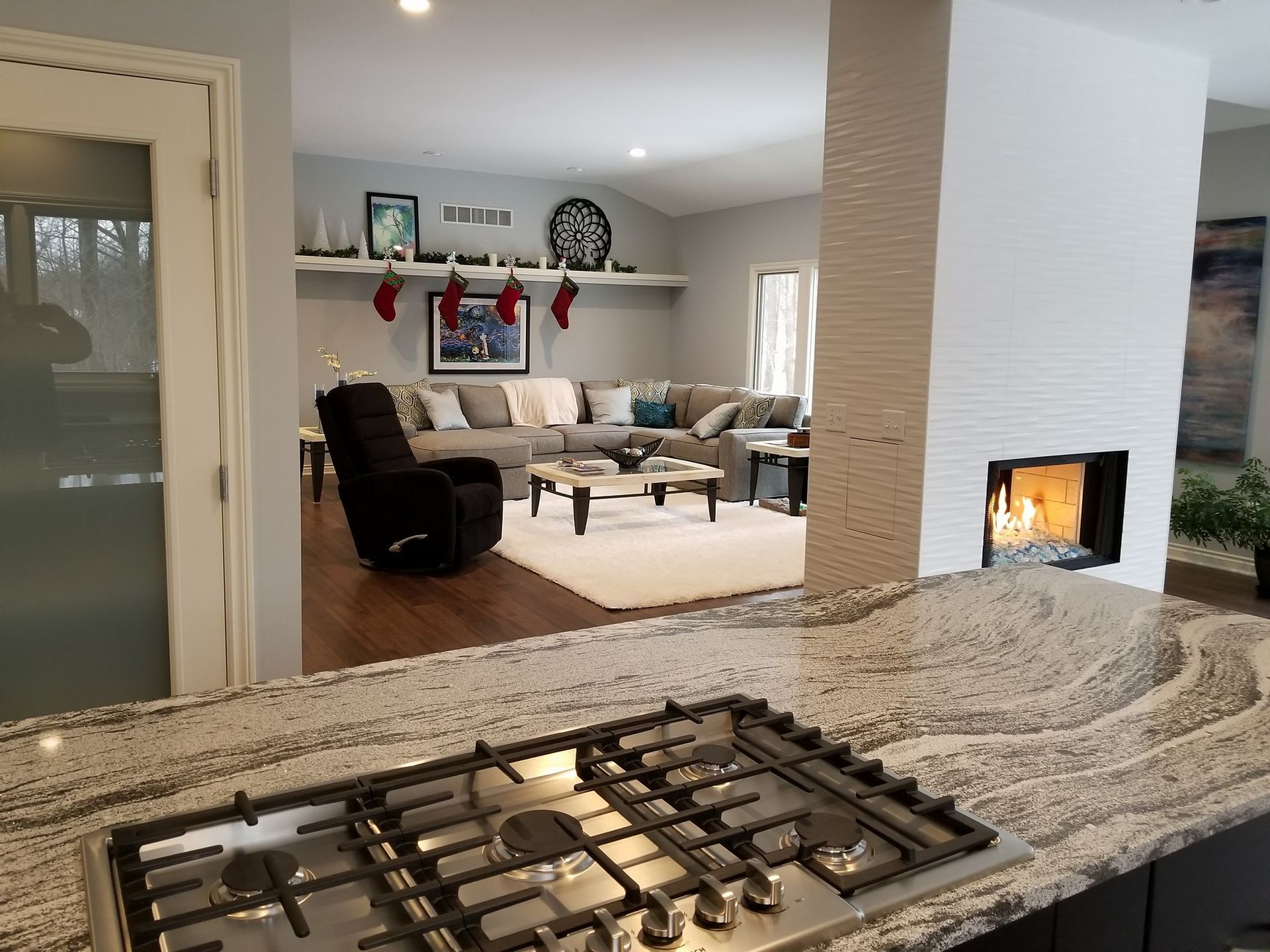 A kitchen with a stove top oven and a fireplace.