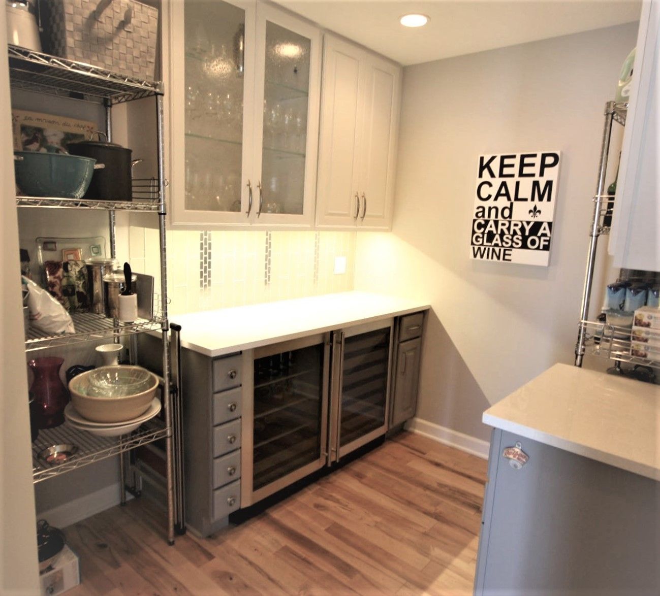 A kitchen with a sign on the wall that says keep calm