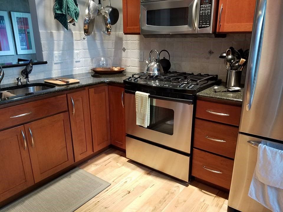 A kitchen with stainless steel appliances and wooden cabinets