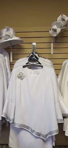 white top with brooch and white skirt