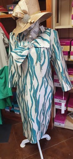 white and teal formal dress and gold hat