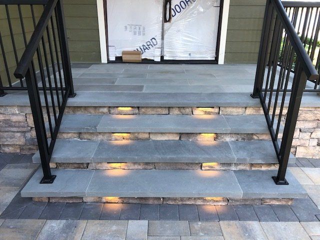 A set of stairs with lights on them and a railing